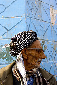 man and blue wall